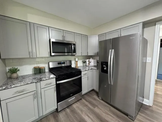 a kitchen with a refrigerator stove and microwave