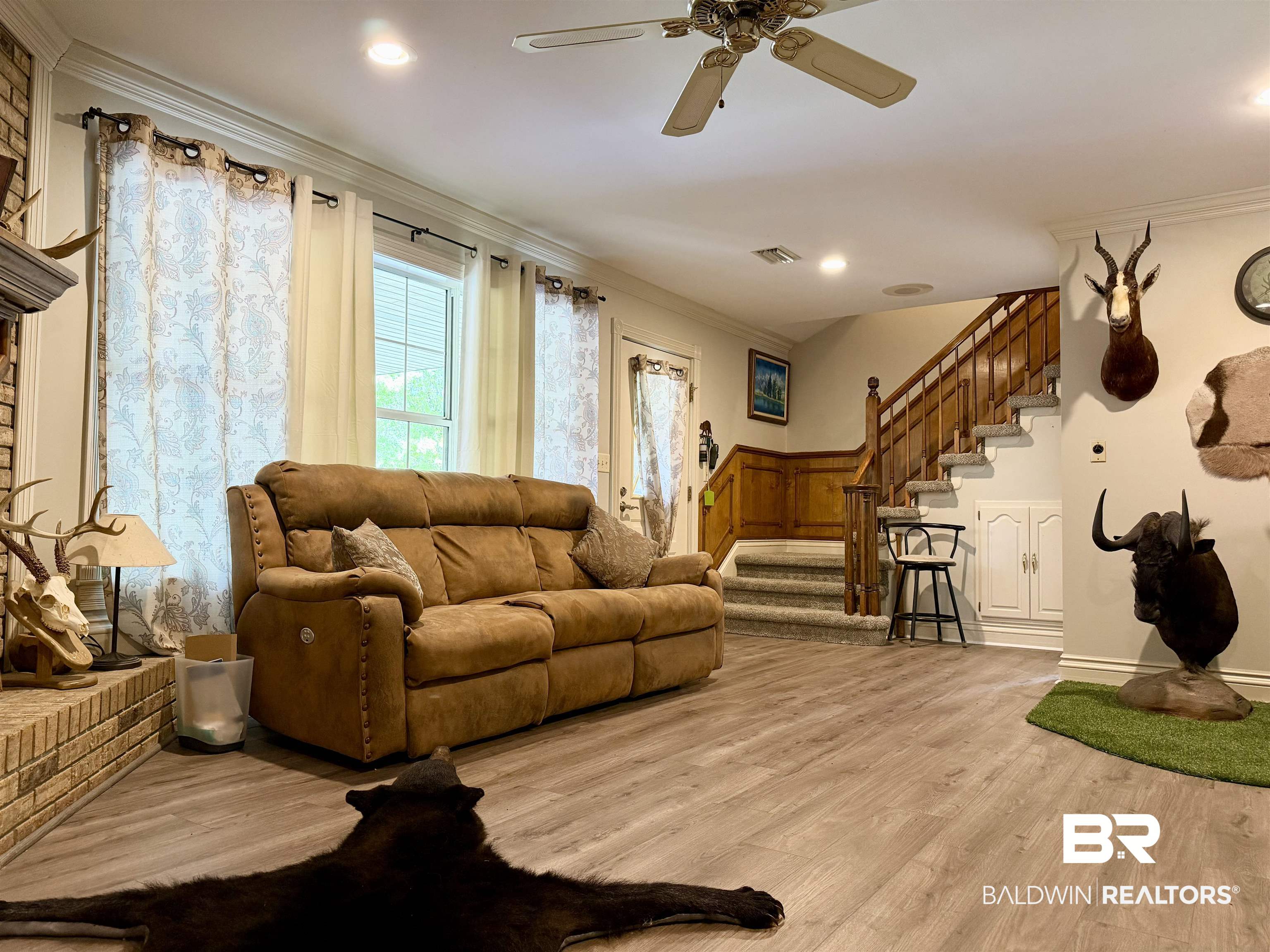 2944 Appleton Road Brewton, AL 36426 - Photo 41 of 65 Living room with ornamental molding, light wood-style floors, wainscoting, a ceiling fan, and a decorative wall