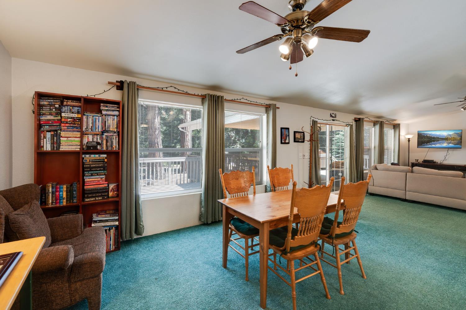 28722 Wood Road Pioneer, CA 95666 - Photo 12 of 39 a dining room with furniture a chandelier and a rug