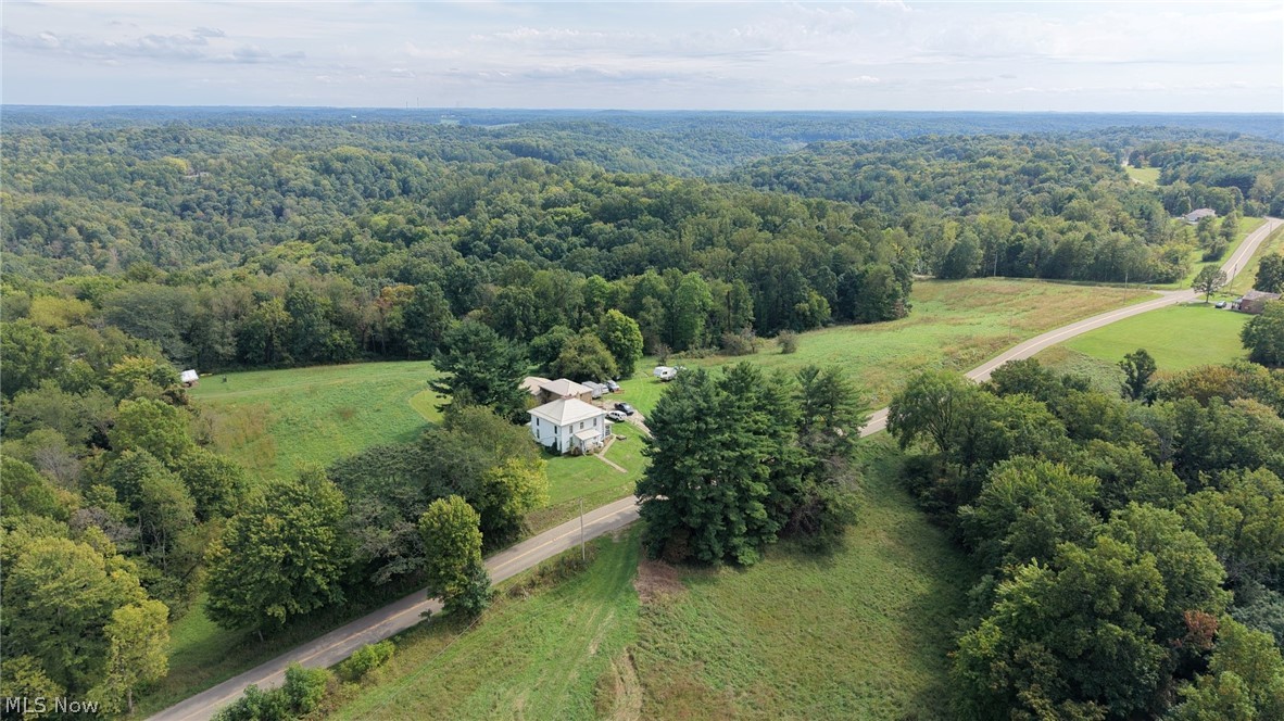 0 Southwest Kings Ridge Road Newcomerstown, OH 43832 - Photo 2 of 3 Expansive surrounding green space with mature trees, a paved road, and distant wooded hills
