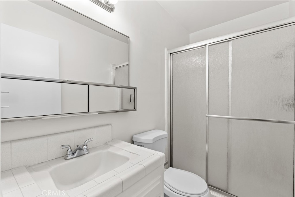 4924 Kester Avenue, Unit 10 Sherman Oaks, CA 91403 - Photo 16 of 17 a white toilet sitting next to a bathroom sink
