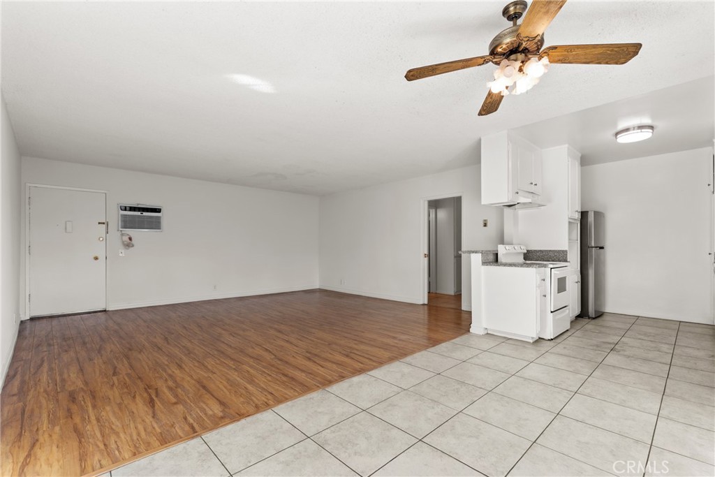 4924 Kester Avenue, Unit 10 Sherman Oaks, CA 91403 - Photo 4 of 17 a view of kitchen and empty room with wooden floor