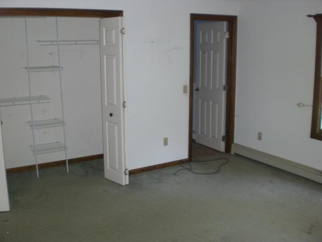 12 Radcliffe Road Mashpee, MA 02649 - Photo 4 of 9 an empty room with a door