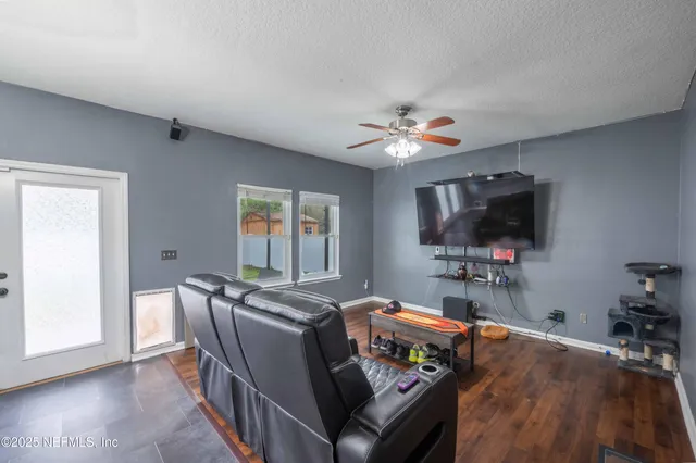 a living room with furniture and a flat screen tv