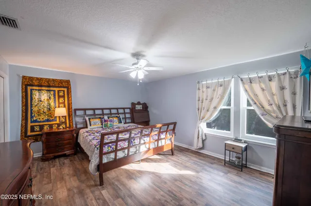 a bedroom with furniture and a window