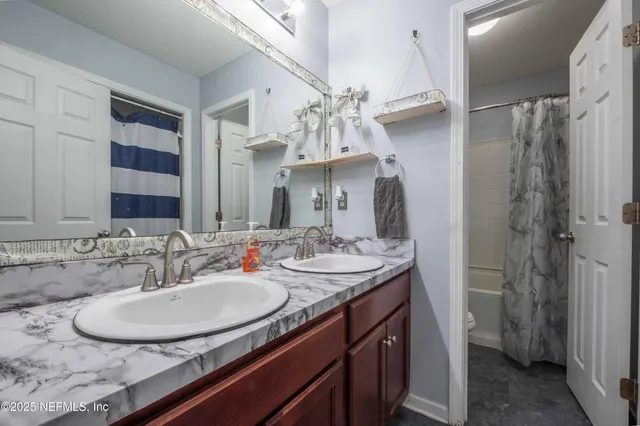 a bathroom with a sink double vanity and a mirror