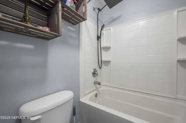 a bathroom with a toilet and a bathtub