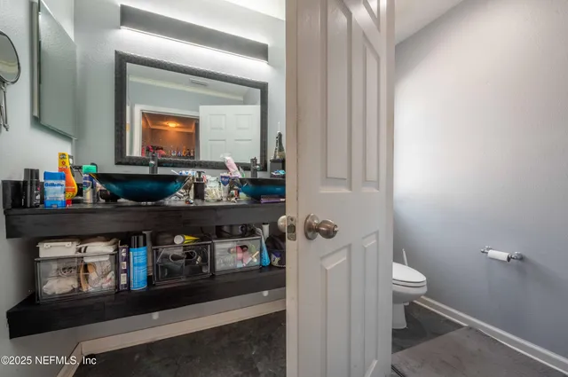 a bathroom with a toilet sink and mirror