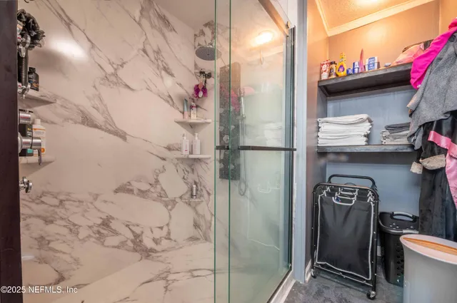 a bathroom with a shower and a sink