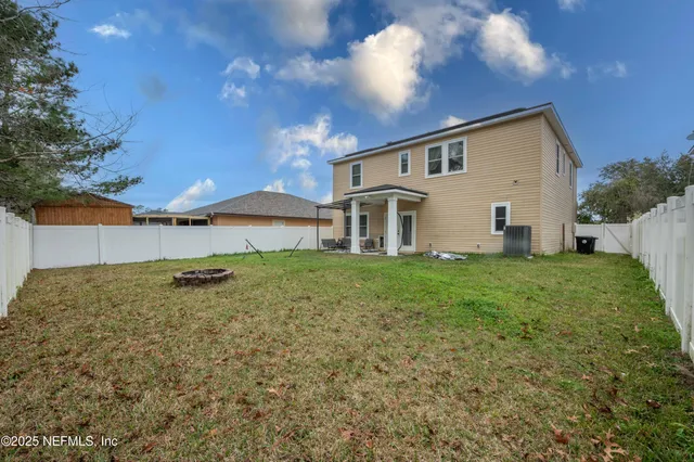 a view of a house with a backyard
