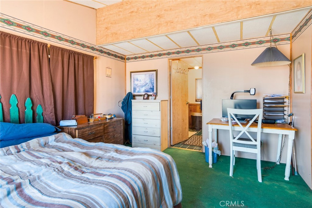 14250 Howe Place Beaumont, CA 92223 - Photo 25 of 31 a bedroom with a bed and a chandelier