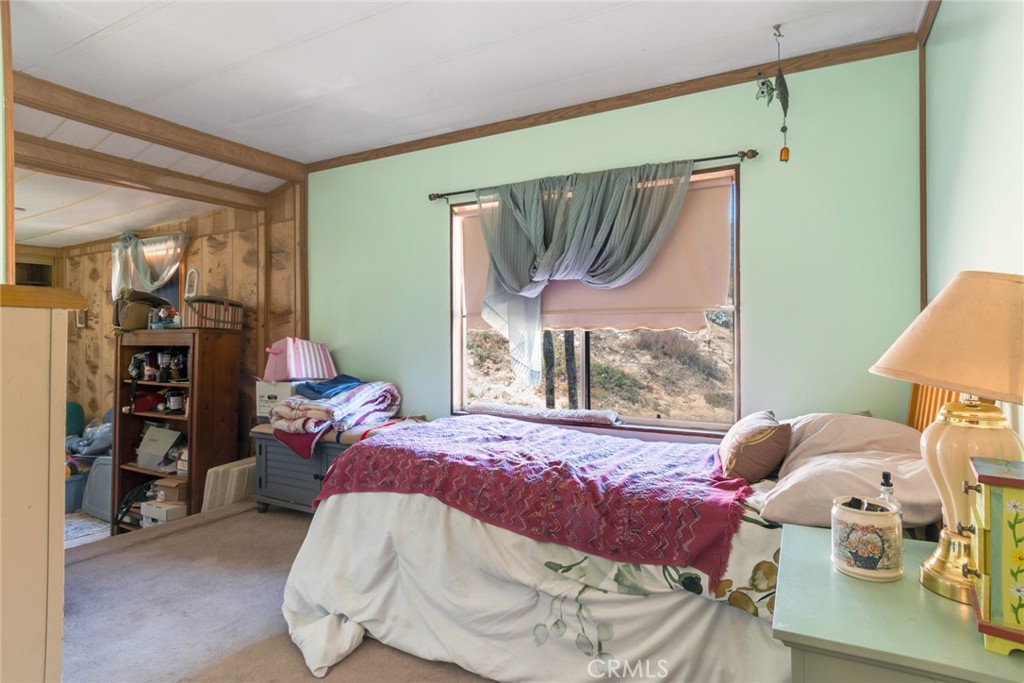 14250 Howe Place Beaumont, CA 92223 - Photo 27 of 31 a bedroom with a bed and a window