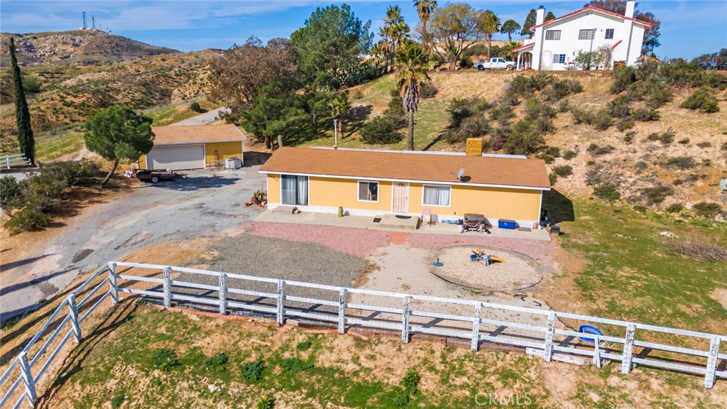 14250 Howe Place Beaumont, CA 92223 - Photo 5 of 31 an aerial view of a house with a yard and large trees