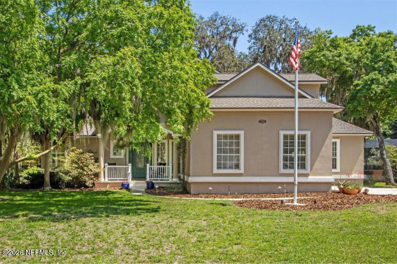 95112 Spring Blossom Court Fernandina Beach, FL 32034 - Photo 1 of 1 front view of a house with a yard