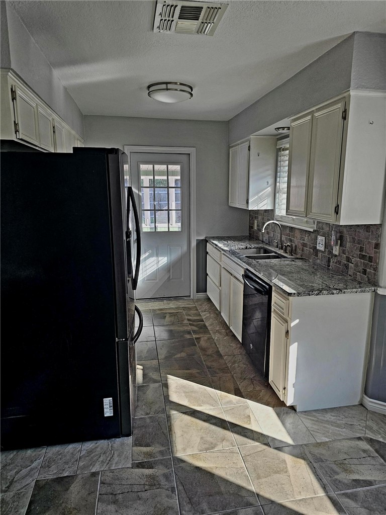 2313 Retta Drive Corpus Christi, TX 78418 - Photo 12 of 18 a kitchen with stainless steel appliances granite countertop a stove a refrigerator and a sink