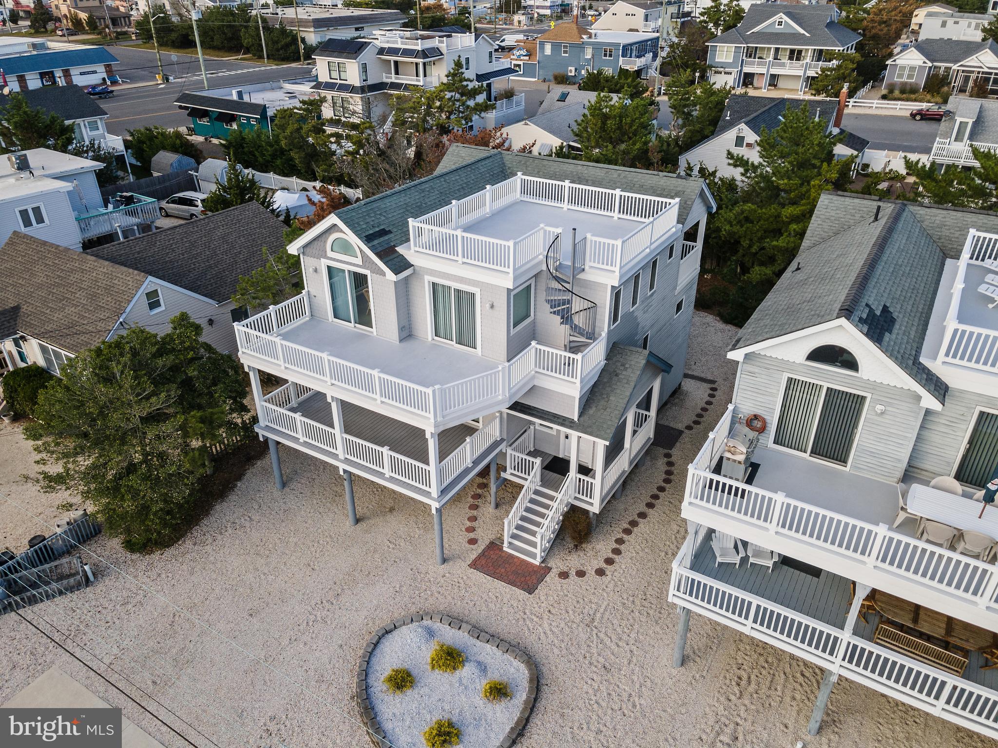 an aerial view of a house with a backyard space and balcony