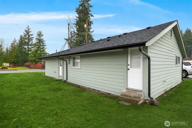 a front view of a house with a garden