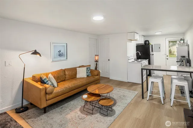 a living room with furniture and wooden floor