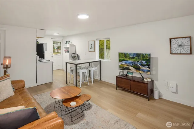 a living room with furniture and wooden floor