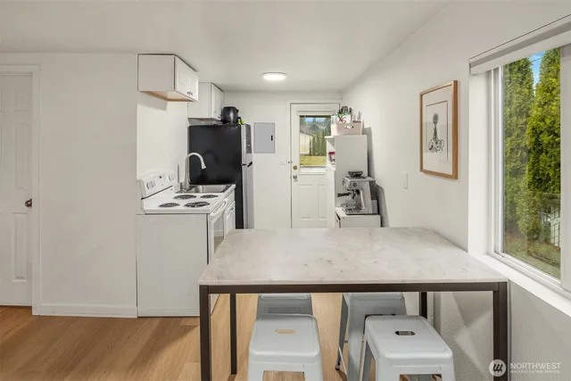 a view of kitchen with furniture and wooden floor