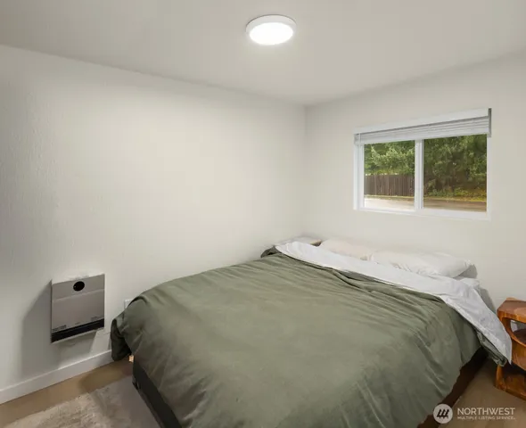 a bedroom with a bed and a window