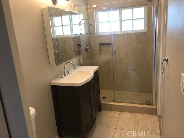 a bathroom with a sink a shower and a mirror