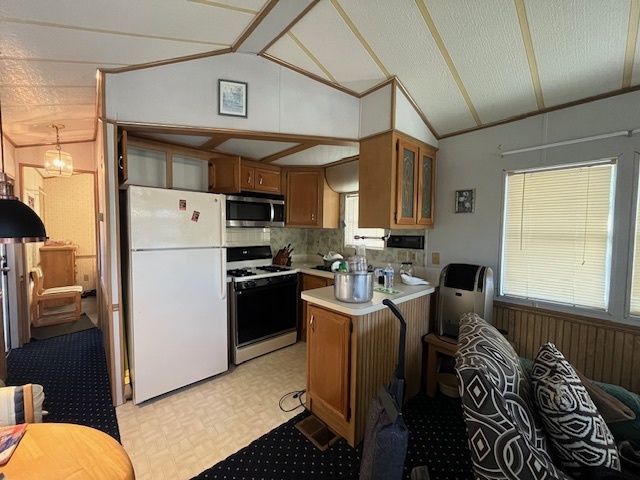 2795 East 28th Road Marseilles, IL 61341 - Photo 14 of 59 a kitchen with stainless steel appliances granite countertop a refrigerator a sink dishwasher a dining table and chairs with wooden floor