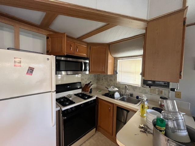 2795 East 28th Road Marseilles, IL 61341 - Photo 15 of 59 a kitchen with stainless steel appliances a stove a sink a refrigerator cabinets and a counter top space