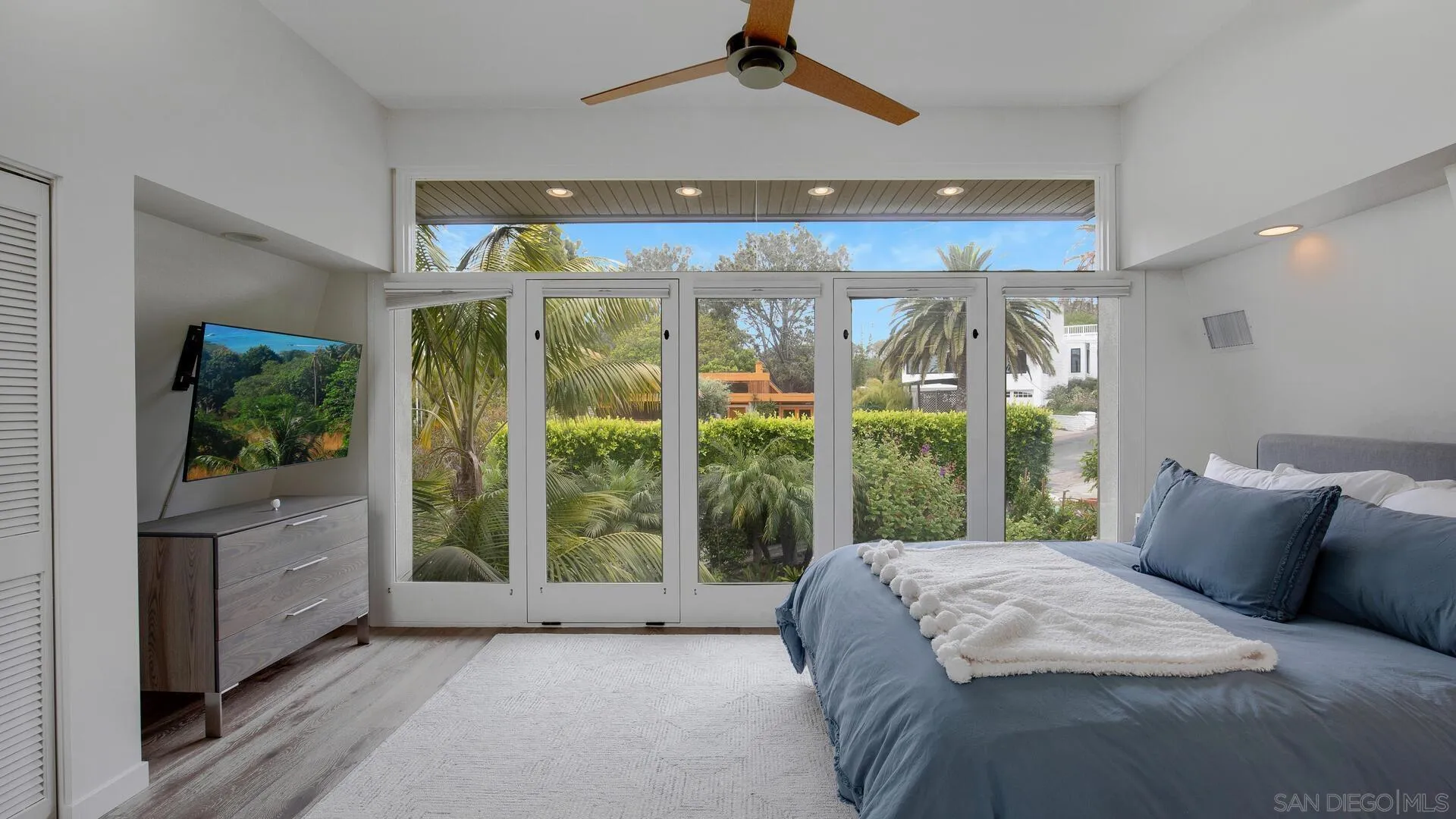 549 Rimini Road Del Mar, CA 92014 - Photo 11 of 32 a bed sitting in a bedroom next to a large window