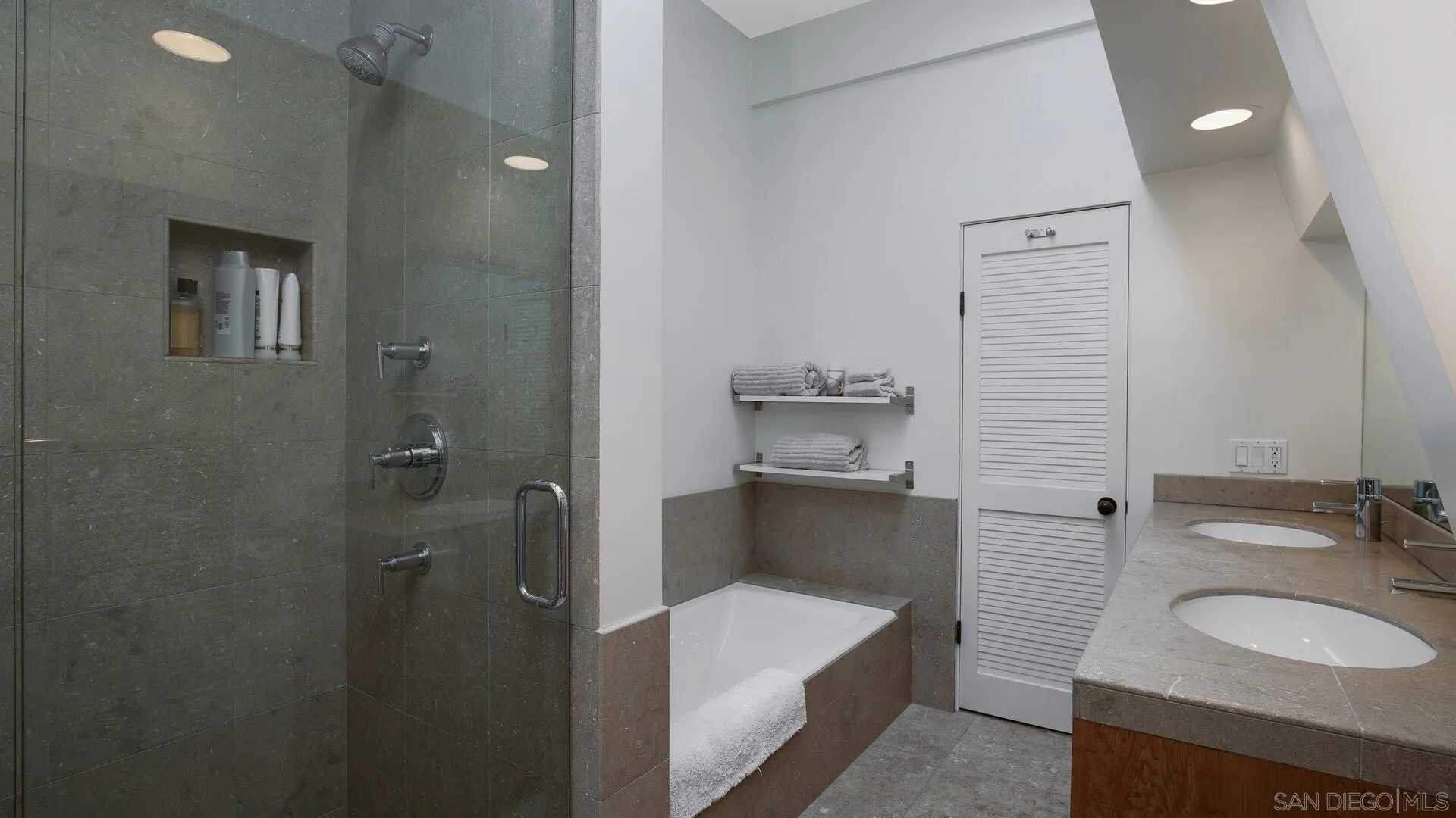 549 Rimini Road Del Mar, CA 92014 - Photo 17 of 32 a bathroom with a granite countertop sink and a mirror