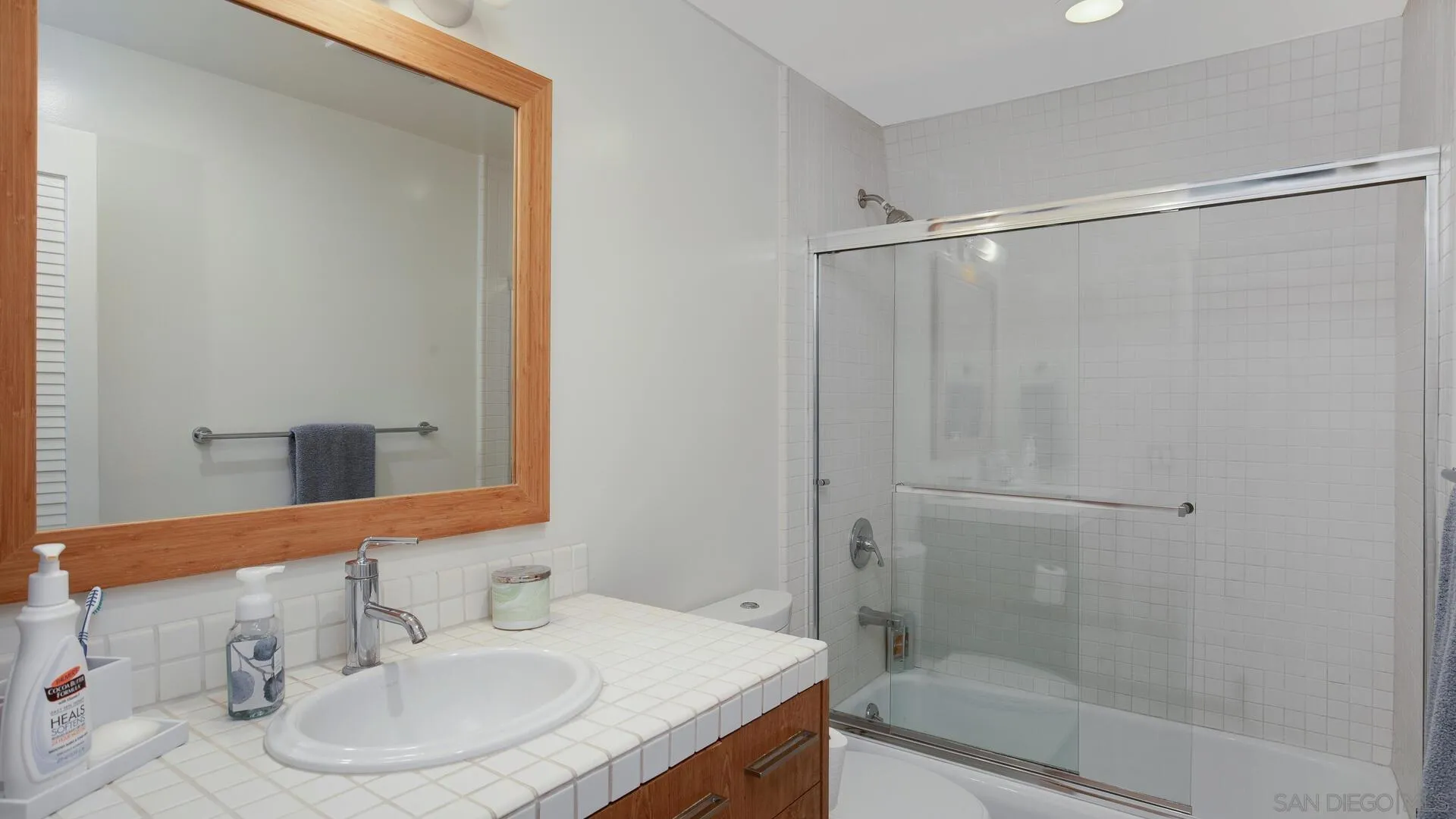 549 Rimini Road Del Mar, CA 92014 - Photo 21 of 32 a bathroom with a sink and a mirror