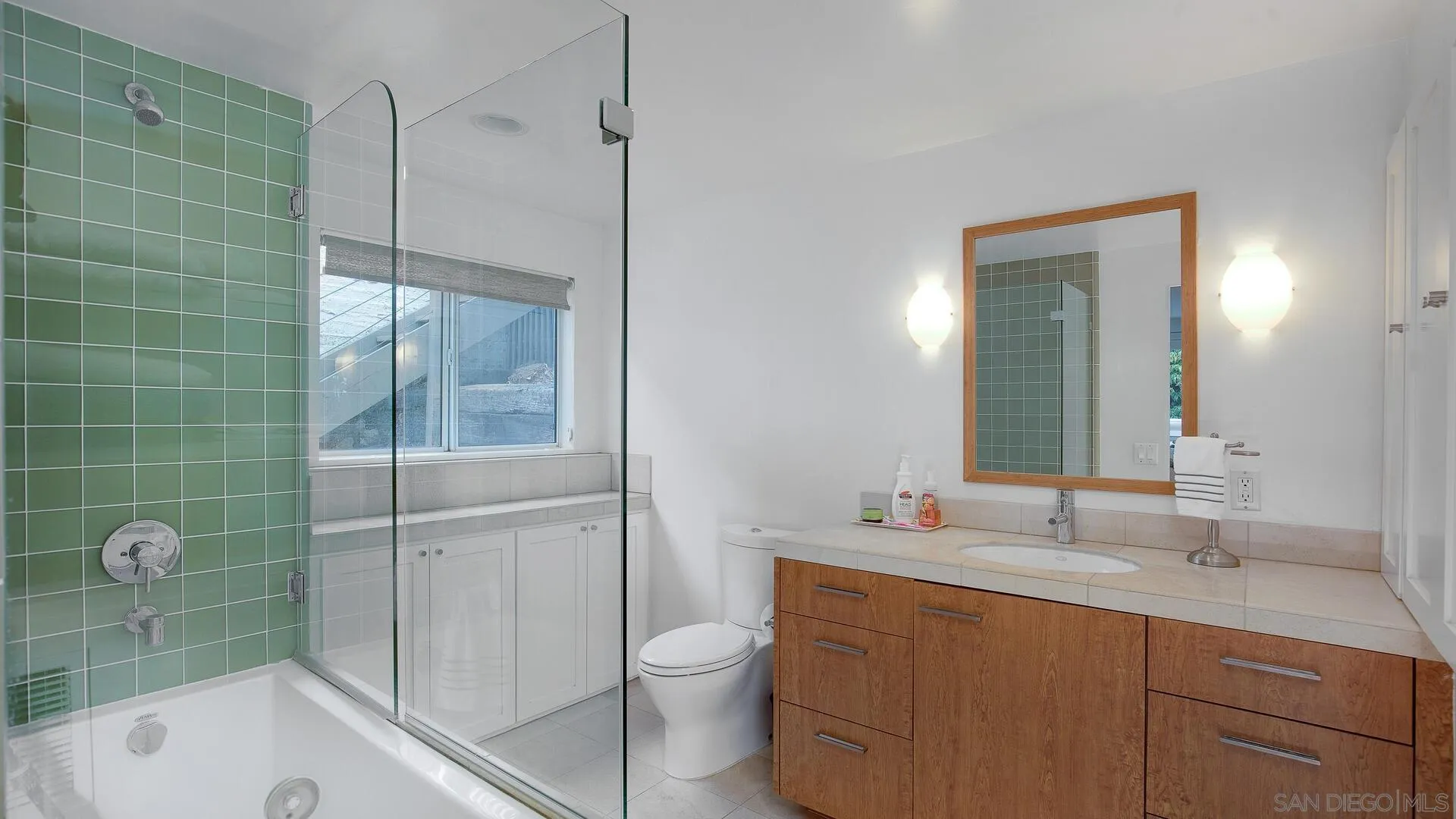 549 Rimini Road Del Mar, CA 92014 - Photo 23 of 32 a bathroom with a sink a toilet and shower
