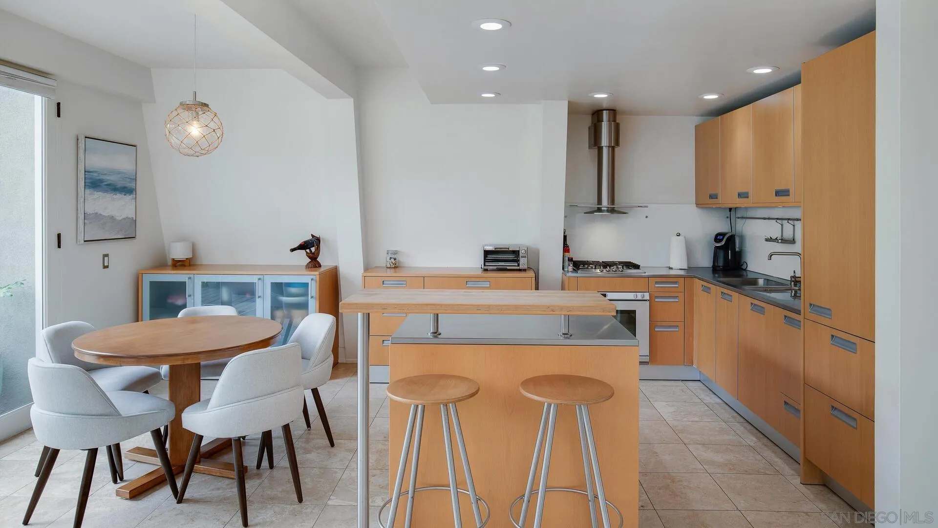 549 Rimini Road Del Mar, CA 92014 - Photo 4 of 32 a kitchen that has a dining table and chairs in it