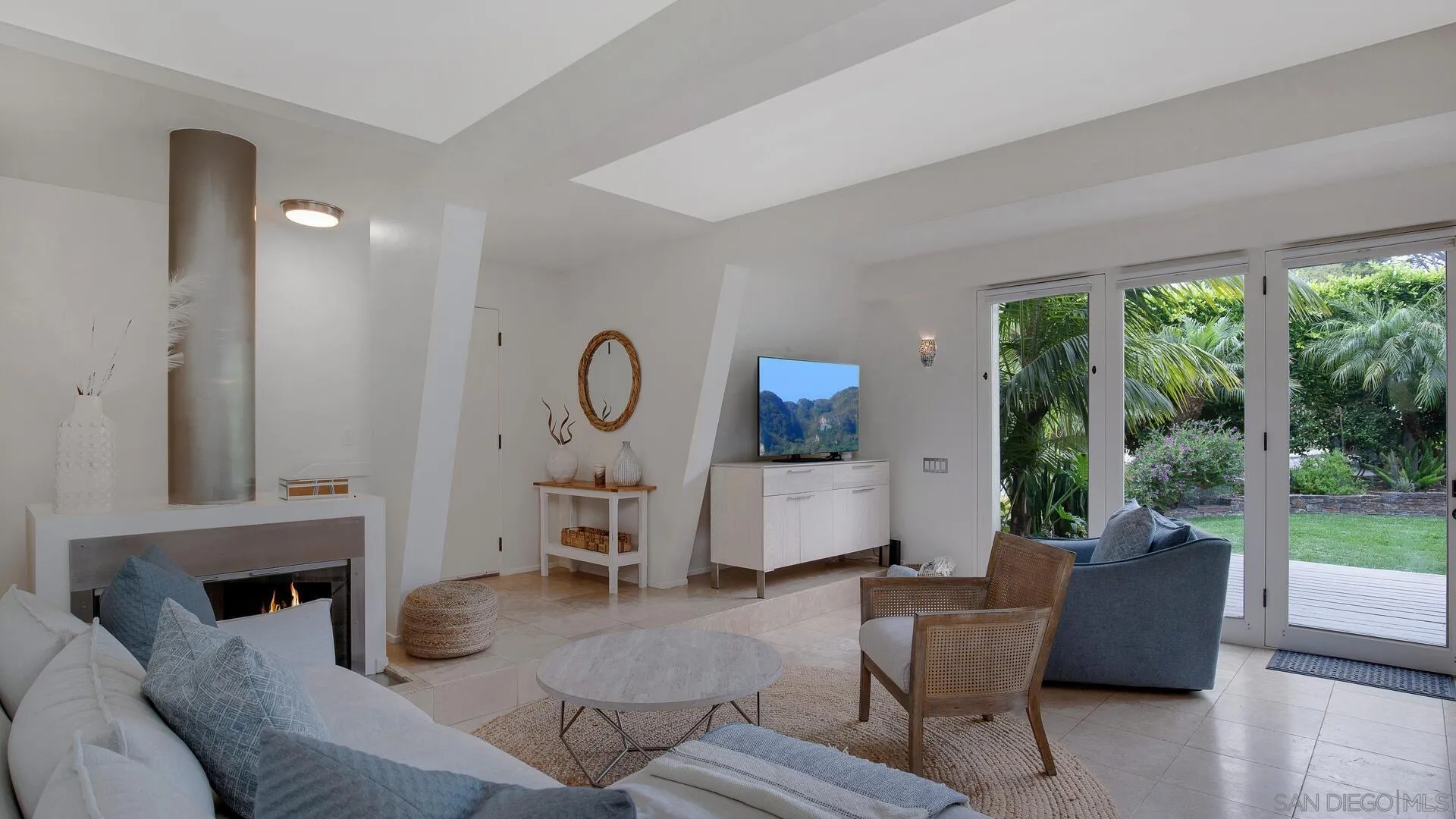 549 Rimini Road Del Mar, CA 92014 - Photo 6 of 32 a living room with patio furniture and a potted plant