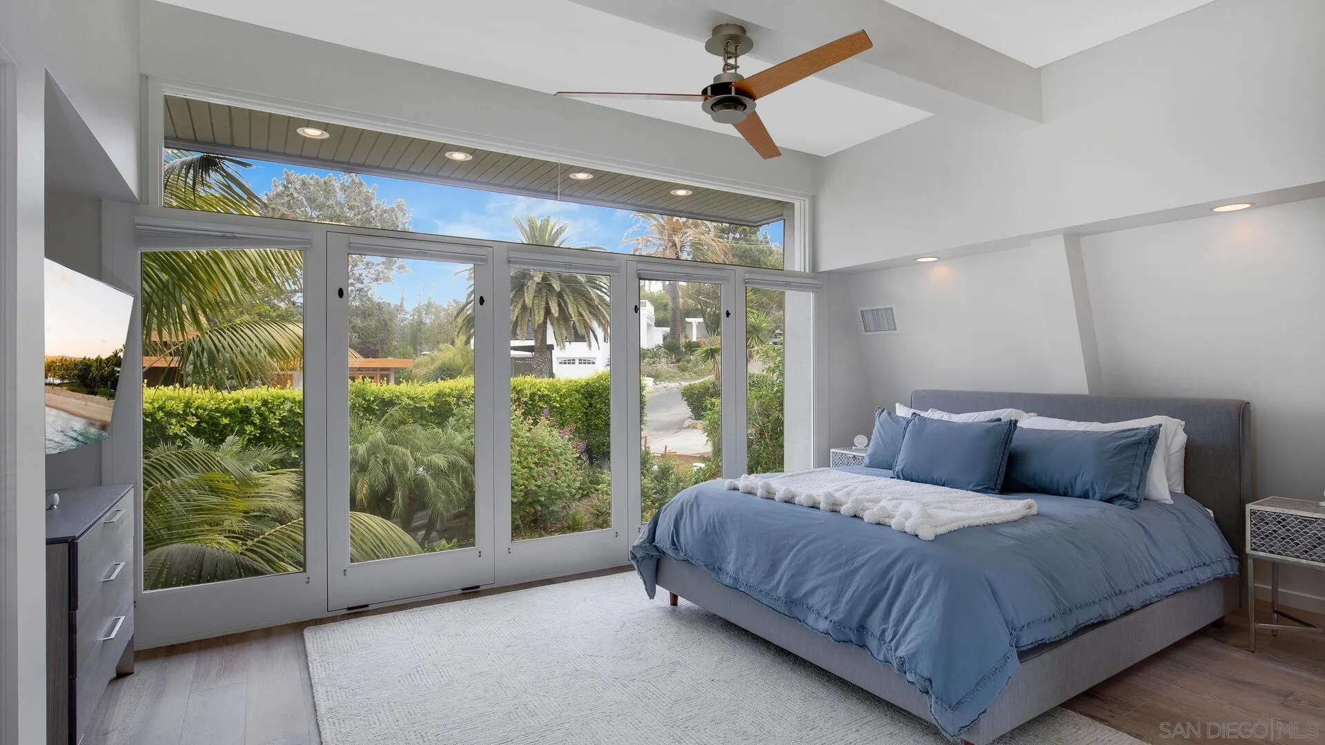 549 Rimini Road Del Mar, CA 92014 - Photo 9 of 32 a bedroom with a large bed and a large window