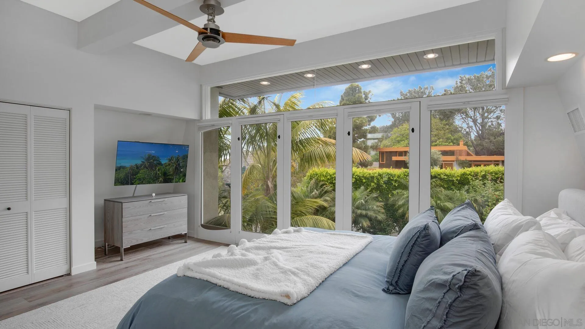 549 Rimini Road Del Mar, CA 92014 - Photo 10 of 32 a bed room with a bed and a large window