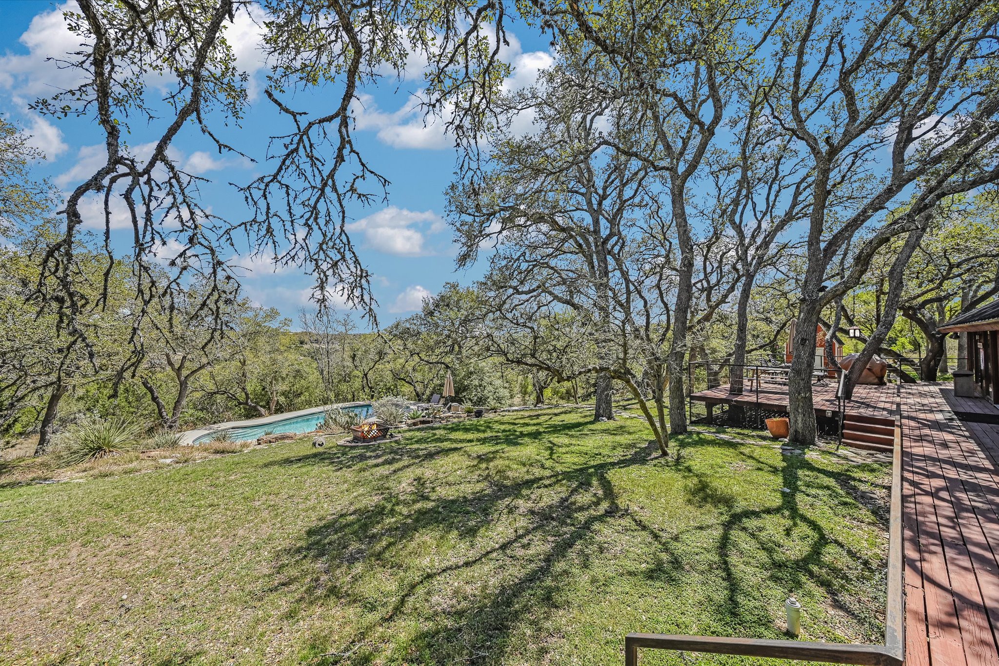411 Whitetail Ridge Austin, TX 78737 - Photo 26 of 38 View of grassy yard with a deck and an outdoor pool