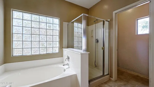 a bathroom with a bathtub and a shower