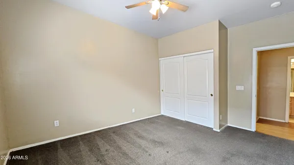 an empty room with a chandelier fan