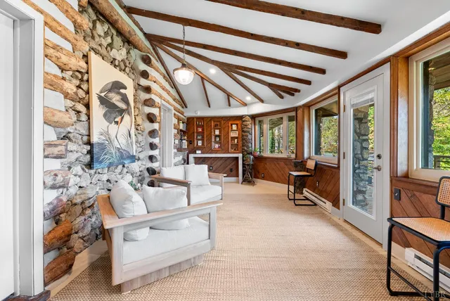 a living room with furniture and a floor to ceiling window