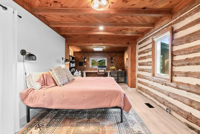 a bed room with a bed and a chair