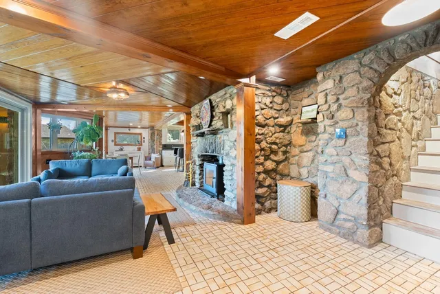 a living room with furniture and a floor to ceiling window