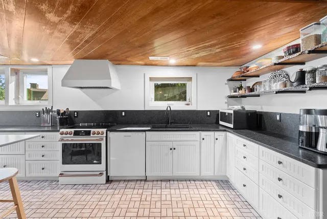 a view of a patio with table and chairs