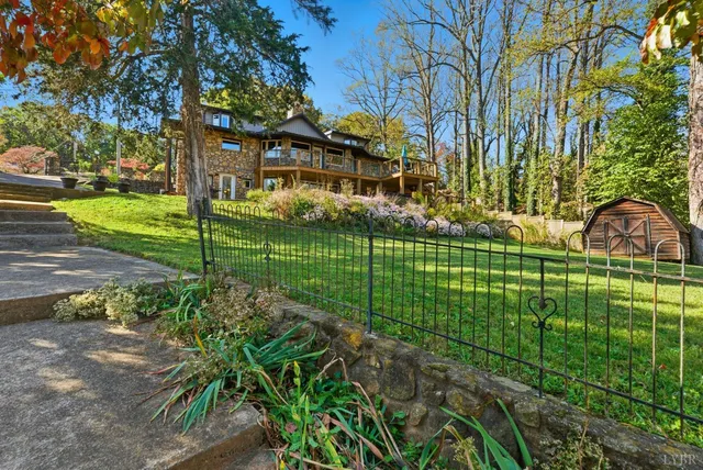 a view of a yard with plants and trees