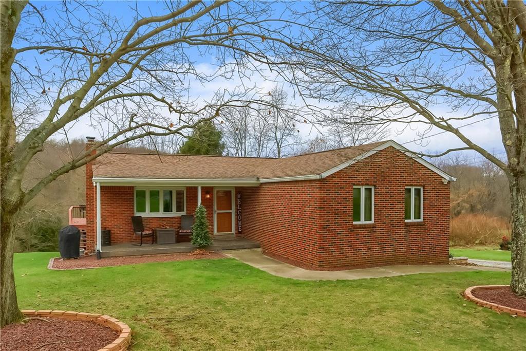 a view of house with backyard