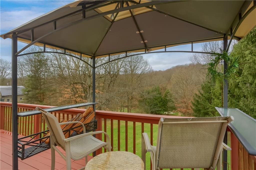 220 Kilgallen Road Butler, PA 16002 - Photo 44 of 50 a view of a balcony with furniture and umbrella