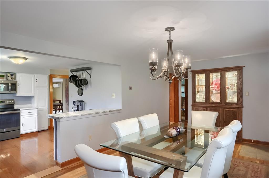 220 Kilgallen Road Butler, PA 16002 - Photo 8 of 50 a view of a dining room with furniture a chandelier and wooden floor