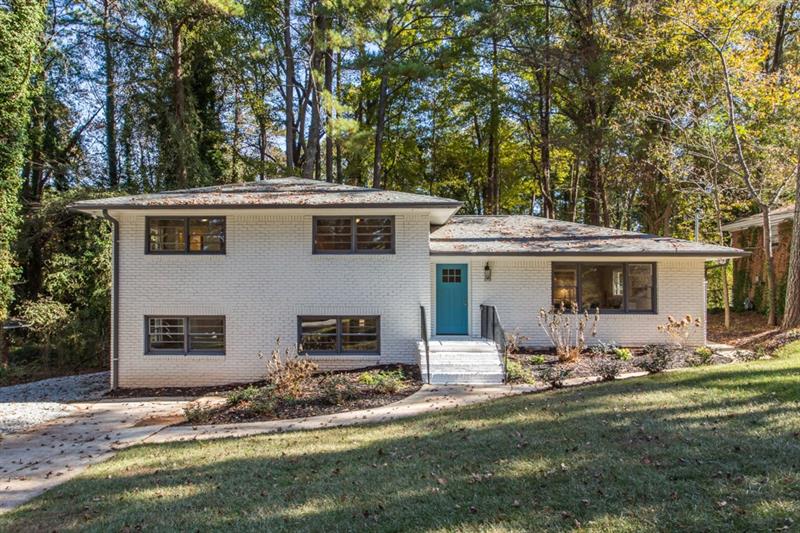 a view of a house with backyard space and sitting area