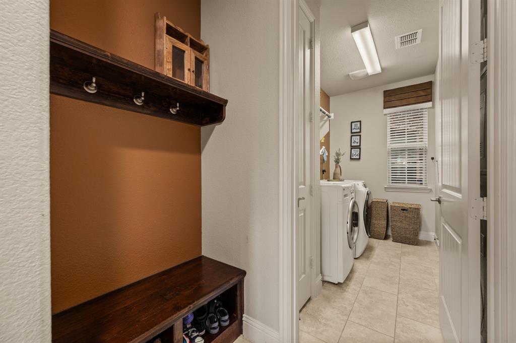 616 Whitetail Road Euless, TX 76039 - Photo 15 of 39 Laundry area with light tile patterned flooring and washer and dryer