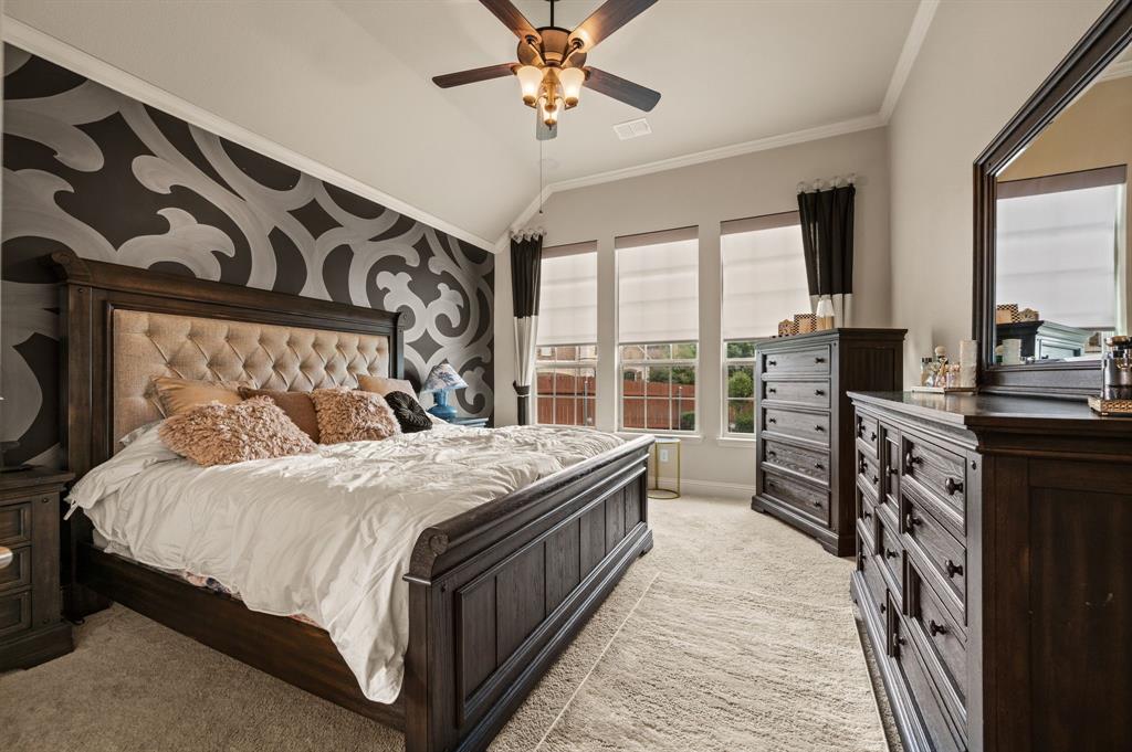 616 Whitetail Road Euless, TX 76039 - Photo 17 of 39 Bedroom featuring ornamental molding, vaulted ceiling, light colored carpet, and a ceiling fan